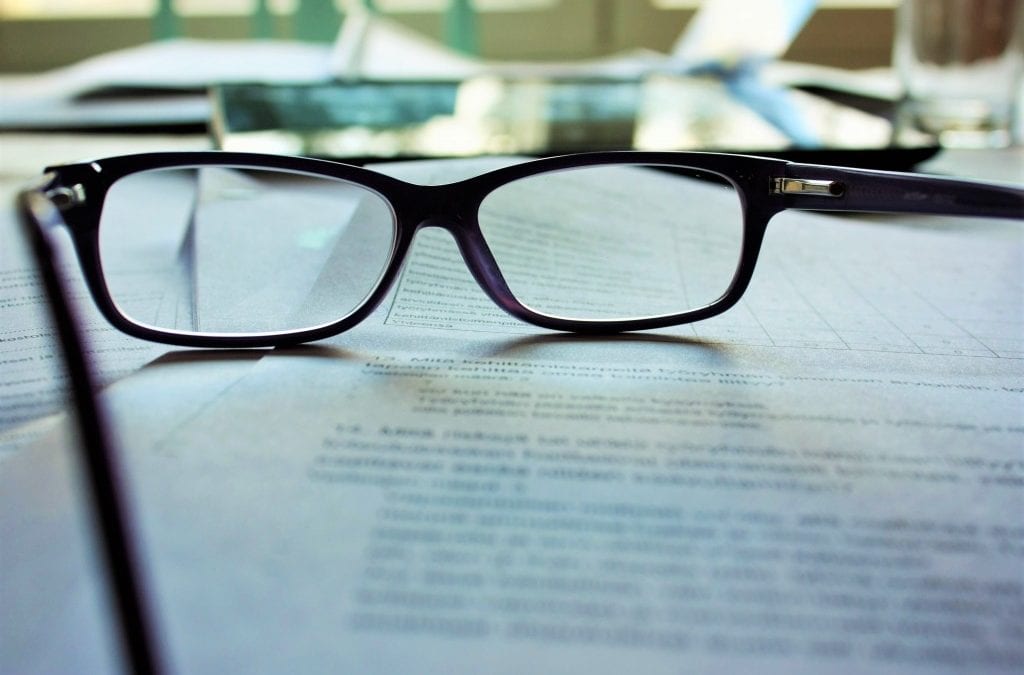 A pair of glasses on a piece of paper | ICD-10 Transition Issues