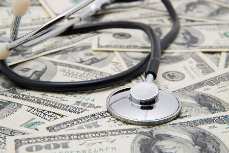 A stethoscope on a pile of money to help illustrate RVU medical billing